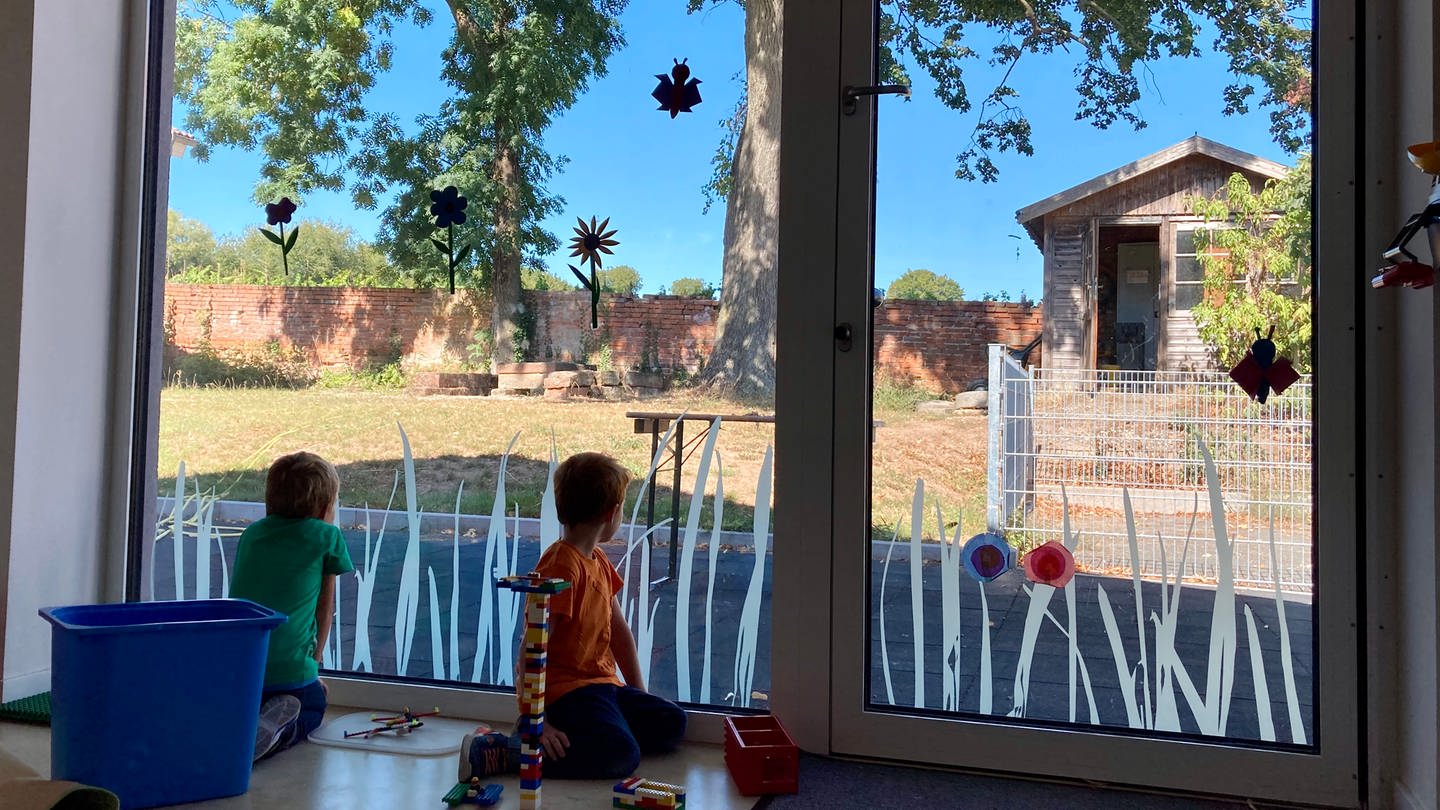 Kinder schauen vom Kinderhaus nach draußen (Foto: Herzenssache)