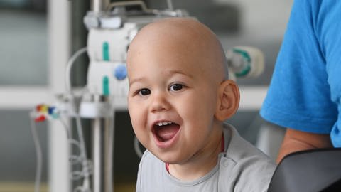 Krebskranker Junge lacht in die Kamera