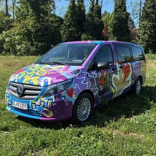 Bunter Herzenssache-Bus auf einer Wiese